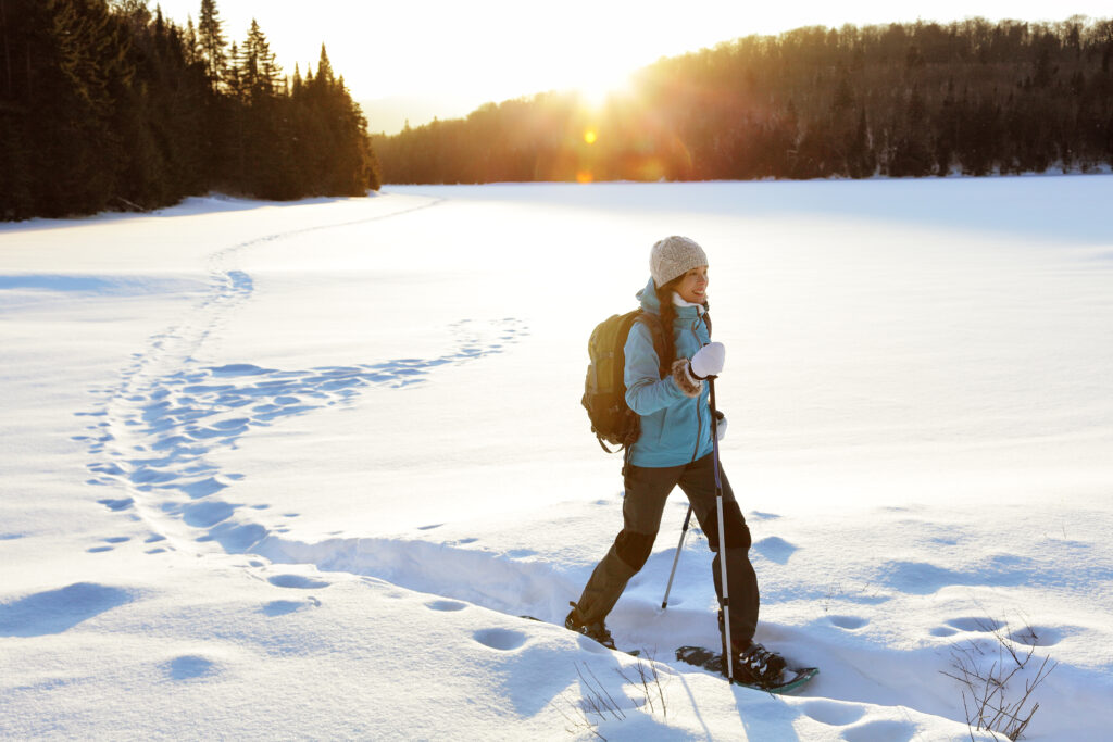 Essential safety tips for the great outdoors in Canada: a woman snowshoeing